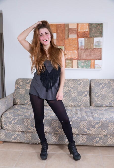 Shapely redheaded cutie Clara D uncovers tiny tits and hairy pussy 